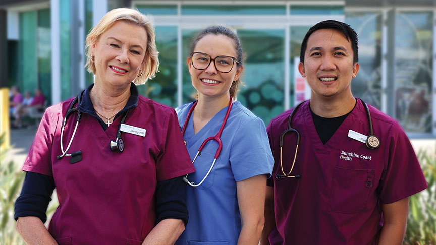 Three Nurse Practitioners in scrubs with stethoscopes stand smiling outside Caloundra Minor Injury and Illness Clinic